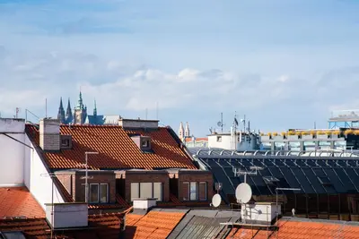 a view of roofs of buildings in a city at Castle View Apartment Prague in Prague