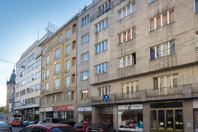 a large building with cars parked in front of it at Castle View Apartment Prague in Prague