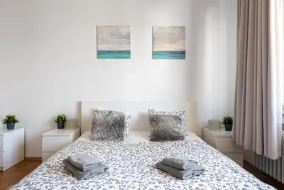 a bedroom with a bed with two pillows on it at Castle View Apartment Prague in Prague