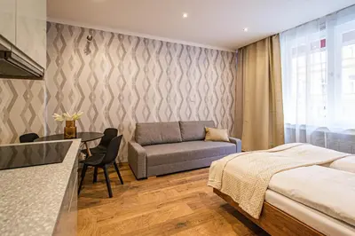 a bedroom with a bed and a couch and a table at Cozy studio in the main city center in Prague