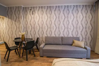 a living room with a couch and a table at Cozy studio in the main city center in Prague