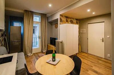 a room with a table with a bottle on it at Cozy studio in the main city center in Prague