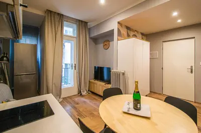 a living room with a table and a bottle of wine at Cozy studio in the main city center in Prague
