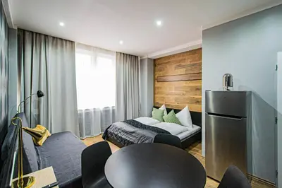a hotel room with a bed and a table and chairs at Cozy studio in the main city center in Prague