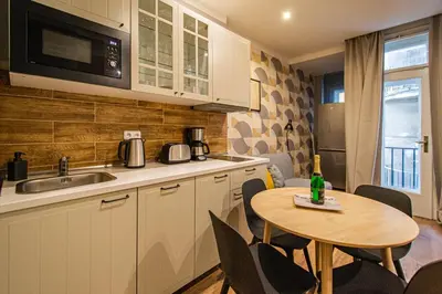 a kitchen with a small table and a kitchen with a microwave at Cozy studio in the main city center in Prague