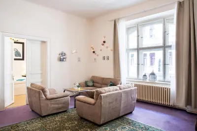 a living room with two chairs and a table at Large 3 BDR APT in the heart of Prague in Prague