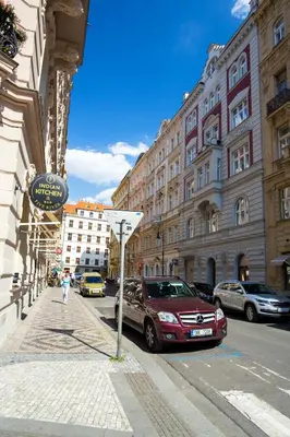 a city street with cars parked on the street at Large 3 BDR APT in the heart of Prague in Prague