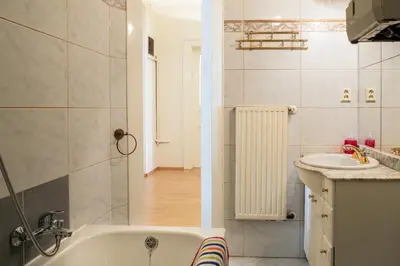 a bathroom with a bath tub and a sink at Large 3 BDR APT in the heart of Prague in Prague