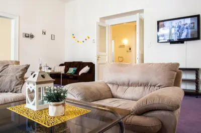 a living room with a couch and a table at Large 3 BDR APT in the heart of Prague in Prague