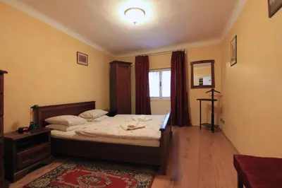 a bedroom with a large bed and a window at 1 Bed Flat - Sleeps 3 - Courtyard - Wifi in Prague