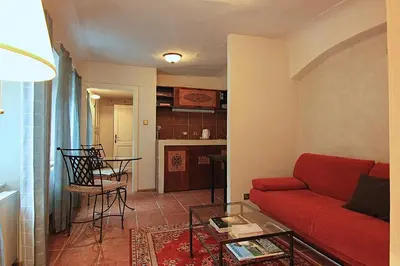 a living room with a red couch and a table at 1 Bed Flat - Sleeps 3 - Courtyard - Wifi in Prague
