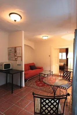 a living room with a red couch and a table at 1 Bed Flat - Sleeps 3 - Courtyard - Wifi in Prague