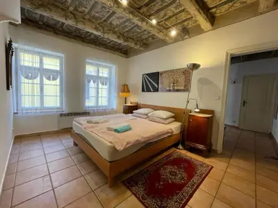 a bedroom with a bed in a room with a ceiling at 1 Bed Flat - Sleeps 4 - Balcony - Wifi in Prague