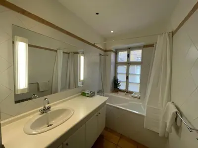 a bathroom with a sink and a mirror and a tub at 1 Bed Flat - Sleeps 4 - Balcony - Wifi in Prague