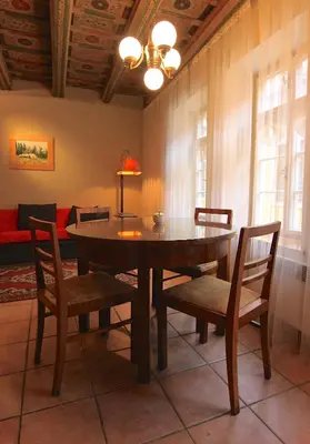 a dining room with a table and chairs and a couch at 1 Bed Flat - Sleeps 4 - Balcony - Wifi in Prague