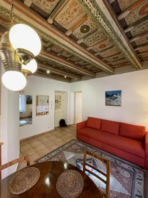 a living room with a red couch and a table at 1 Bed Flat - Sleeps 4 - Balcony - Wifi in Prague