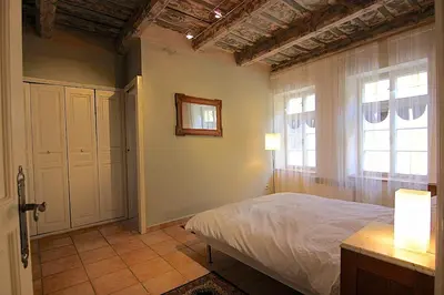 a bedroom with a bed and two windows at 1 Bed Flat - Sleeps 4 - Balcony - Wifi in Prague
