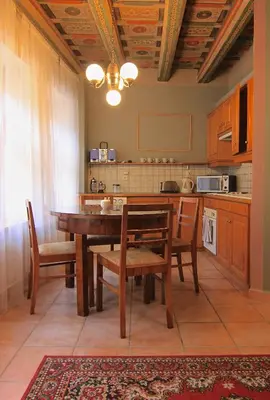 a kitchen with a wooden table and chairs and a counter at 1 Bed Flat - Sleeps 4 - Balcony - Wifi in Prague