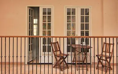two chairs and a table on a balcony at 1 Bed Flat - Sleeps 4 - Balcony - Wifi in Prague