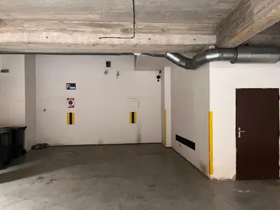 an empty room with white walls and a brown door at City Centre Garden Apartment with parking in Prague