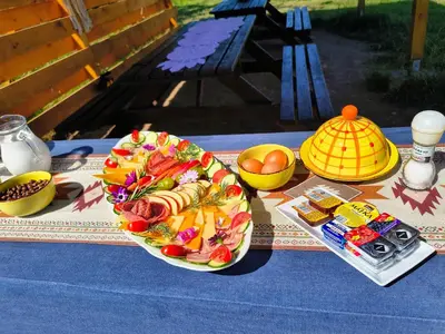 a plate of food on top of a table at Teepee Camp Lounky in Chodouny