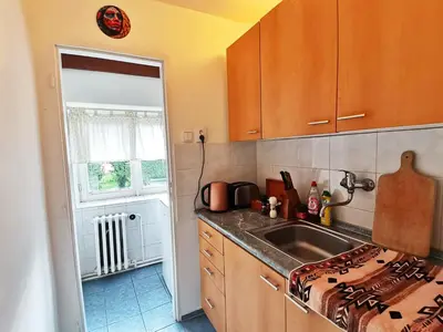 a kitchen with wooden cabinets and a sink at Teepee Camp Lounky in Chodouny