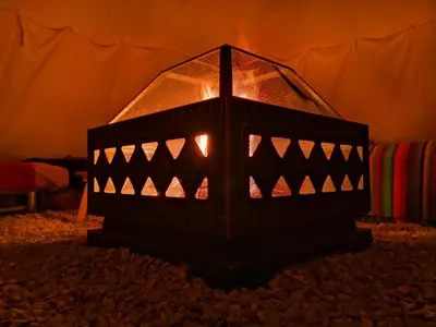 a lit up lantern sitting on the floor in a room at Teepee Camp Lounky in Chodouny