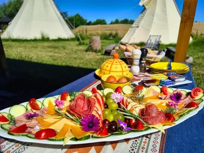 a plate of food on top of a table at Teepee Camp Lounky in Chodouny
