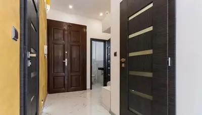 a hallway with wooden doors in a bathroom at Luxury Apartment on Wenceslas Square in Prague