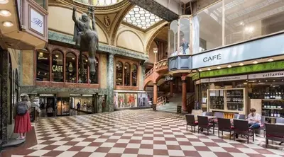 a shopping mall with a checkered floor and a large building at Luxury Apartment on Wenceslas Square in Prague