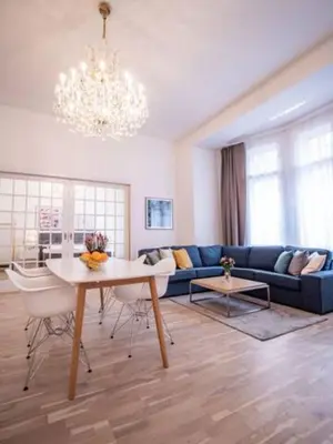 a living room with a blue couch and a table at Top class apartment in old town 2 bedrooms in Prague