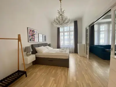 a bedroom with a bed and a chandelier at Top class apartment in old town 2 bedrooms in Prague