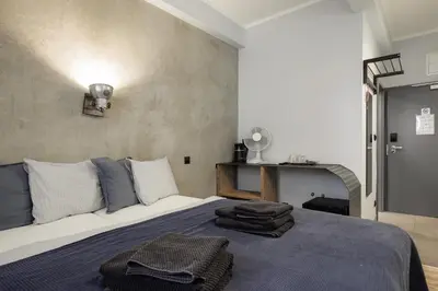 a bedroom with a bed with towels on it at Residence Řipská 26 in Prague