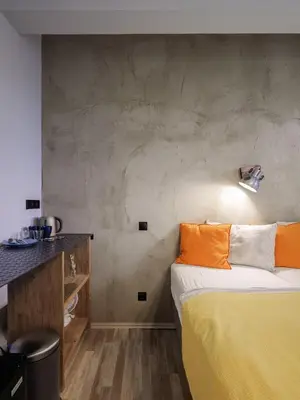 a room with a bed with orange pillows on it at Residence Řipská 26 in Prague