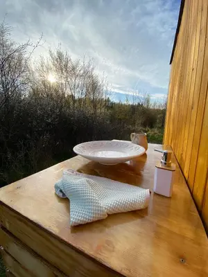 a sink sitting on top of a wooden deck at Maringotka Za Trnkou in Točník