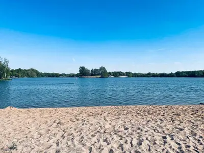 a beach with a large body of water at Královské apartmá kolonáda in Poděbrady