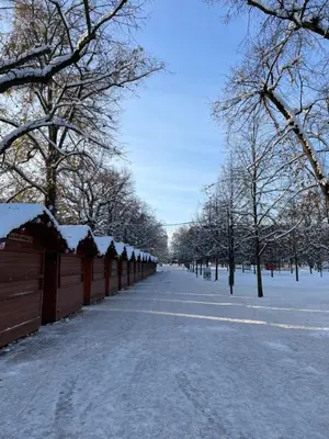 a sidewalk covered in snow next to a fence at Královské apartmá kolonáda in Poděbrady