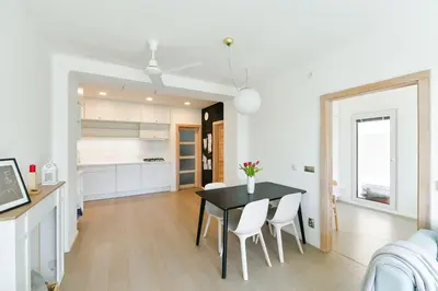 a kitchen and dining room with a black table and chairs at Královské apartmá kolonáda in Poděbrady