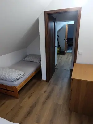 a room with a bed and a hallway with a mirror at Apartmán v blízkosti města Štětí in Štětí