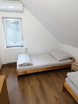 a bed in a room with a window at Apartmán v blízkosti města Štětí in Štětí