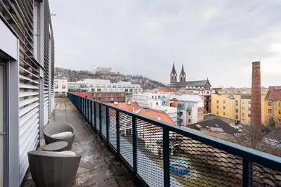a white closet with a door and a shelf at Stylish penthouses featuring a terrace in Prague in Prague