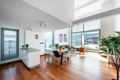 a church with two spires on top of a city at Stylish penthouses featuring a terrace in Prague in Prague