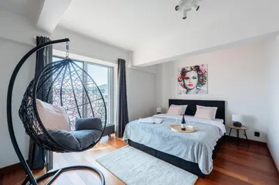 a bedroom with two beds and a mirror at Stylish penthouses featuring a terrace in Prague in Prague