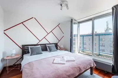 a bedroom with a swing bed and a chair at Stylish penthouses featuring a terrace in Prague in Prague