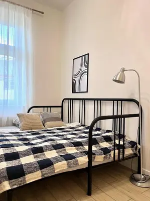 a bedroom with a bed with a checkered blanket at Quiet apartment close to center in Prague