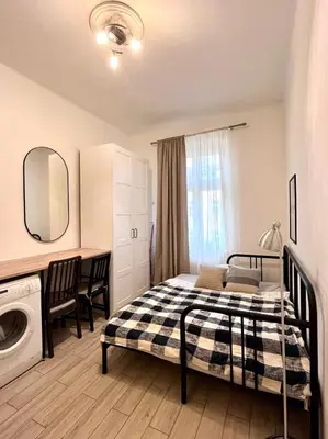 a bedroom with a bed and a washing machine at Quiet apartment close to center in Prague
