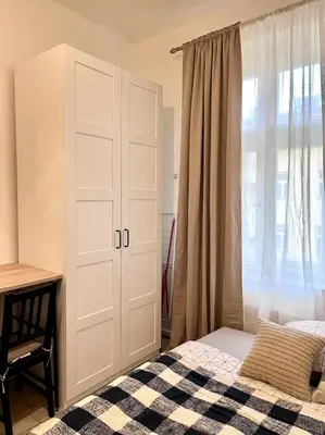 a bedroom with a white cabinet and a bed at Quiet apartment close to center in Prague