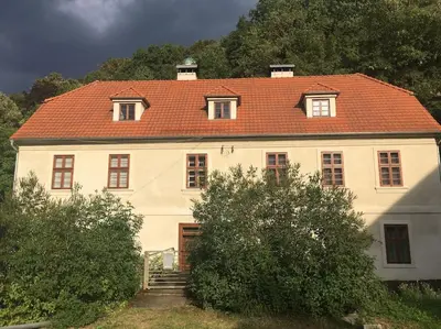 a large white house with a red roof at Kamenný dům s výhledem na zámek 20km od Prahy in Nižbor