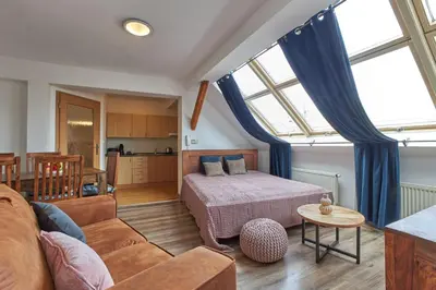 a living room with a bed and a couch at Narodni - Old Town Residence in Prague