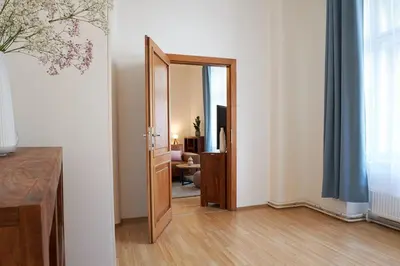 a hallway with a door open to a living room at Narodni - Old Town Residence in Prague